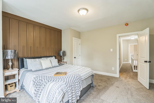 bedroom with light carpet and baseboards