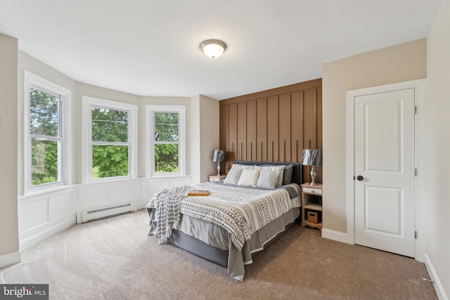 carpeted bedroom with baseboard heating and multiple windows