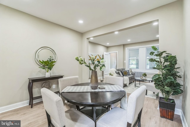 dining area featuring light wood finished floors, baseboards, and recessed lighting