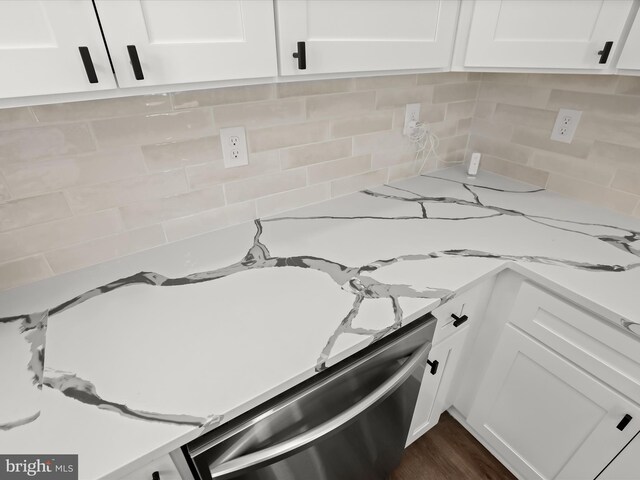 3817 Arbutus Ave, Baltimore, MD 21207 - kitchen view of stainless steel dishwasher, white cabinetry, decorative backsplash, and light stone counters