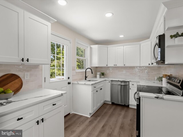 3817 Arbutus Ave, Baltimore, MD 21207 - kitchen with appliances with stainless steel finishes, a sink, backsplash, white cabinets, and recessed lighting