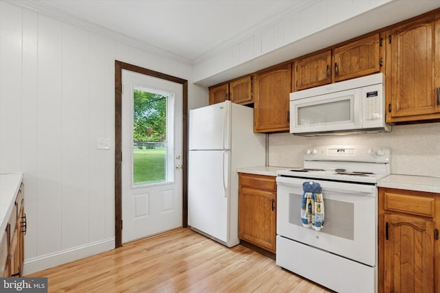 10 Mccarthy Ave, Langhorne, PA 19047 - kitchen featuring white appliances, ornamental molding, light wood-type flooring, brown cabinets, and light countertops