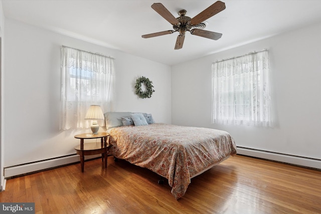 10 Mccarthy Ave, Langhorne, PA 19047 - bedroom with multiple windows, a baseboard radiator, and wood finished floors