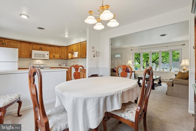 10 Mccarthy Ave, Langhorne, PA 19047 - dining area with a chandelier, light carpet, and a baseboard radiator
