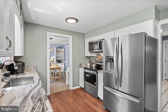 230 Aqua Ln, Delran, NJ 08075 - kitchen with stainless steel appliances, a sink, white cabinetry, light stone countertops, and dark wood finished floors
