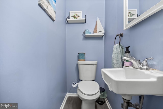 230 Aqua Ln, Delran, NJ 08075 - half bathroom featuring wood finished floors, baseboards, toilet, and a sink