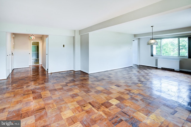 4201 Cathedral Ave NW Unit 1004E, Washington, DC 20016 - unfurnished living room with radiator and baseboards