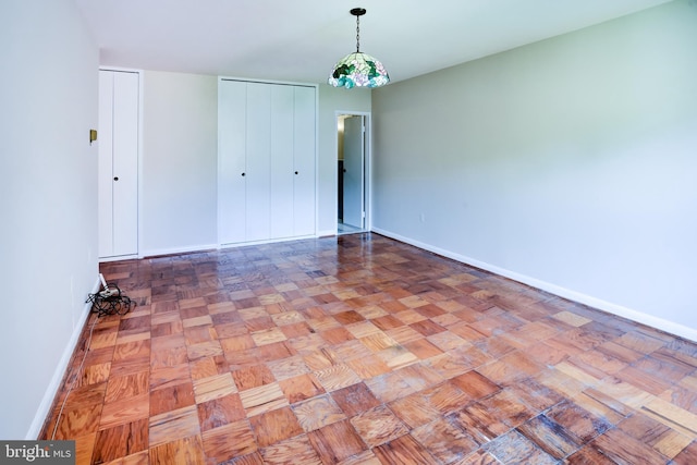 4201 Cathedral Ave NW Unit 1004E, Washington, DC 20016 - unfurnished bedroom with baseboards and multiple closets