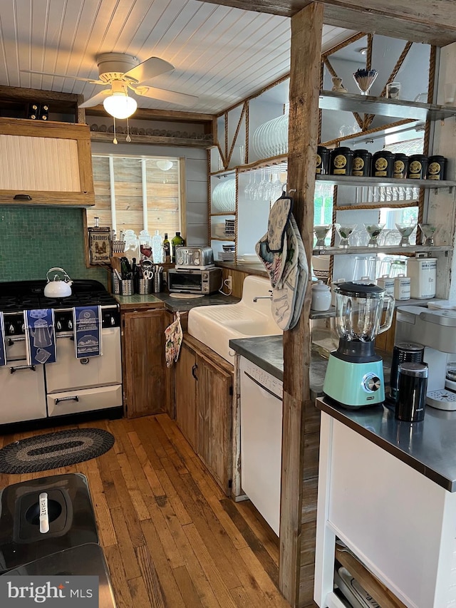 204 Coral St, Beach Haven, NJ 08008 - kitchen featuring gas range oven, hardwood / wood-style floors, ceiling fan, brown cabinets, and dark countertops