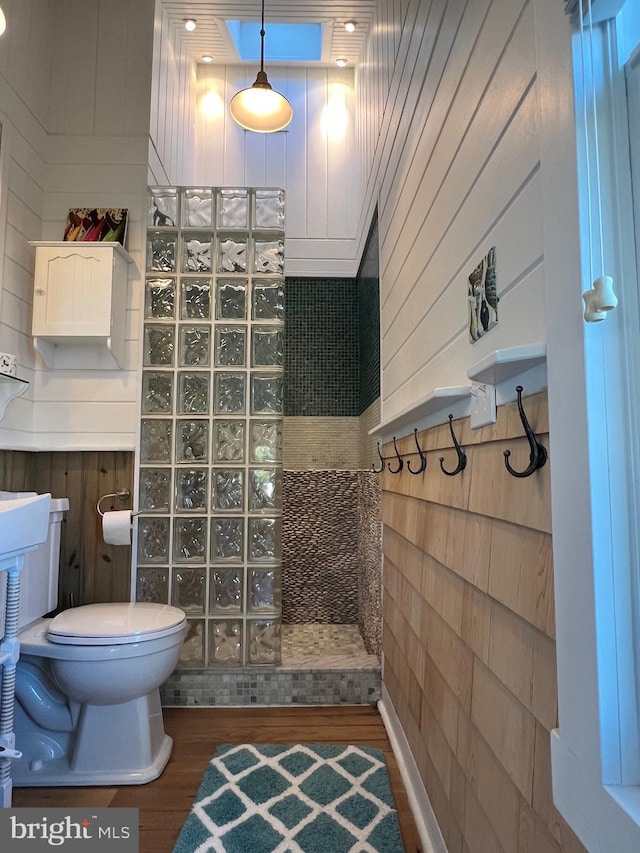 204 Coral St, Beach Haven, NJ 08008 - bathroom with a walk in shower, wood finished floors, toilet, and wood walls