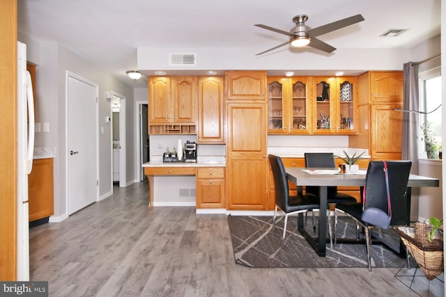 220 Brian Dr, Enola, PA 17025 - kitchen featuring light countertops, wood finished floors, glass insert cabinets, baseboards, and recessed lighting