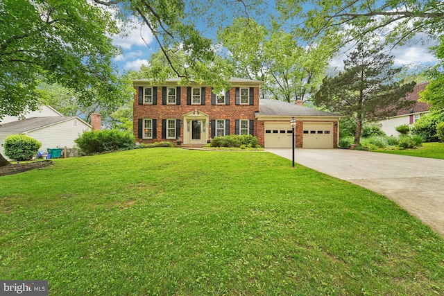 15320 Durant St, Silver Spring, MD 20905 - colonial inspired home featuring a garage, driveway, brick siding, and a front lawn