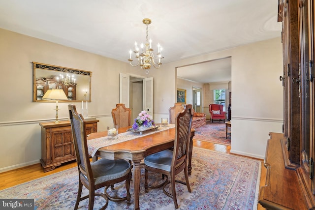 15320 Durant St, Silver Spring, MD 20905 - dining area with a chandelier, light wood-style flooring, and baseboards