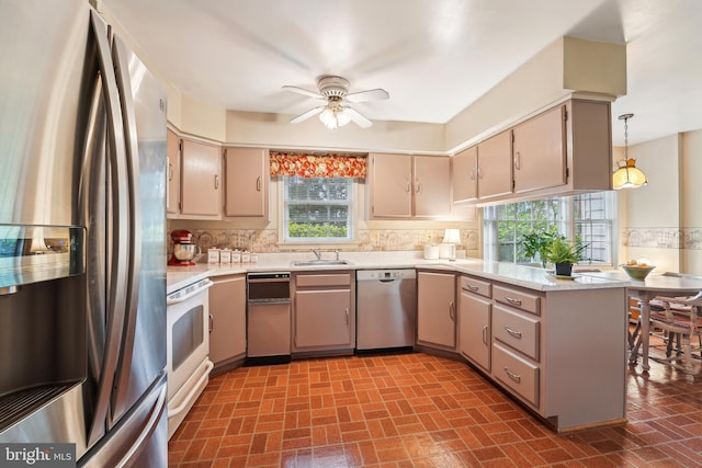 15320 Durant St, Silver Spring, MD 20905 - kitchen with appliances with stainless steel finishes, a peninsula, a sink, and light countertops