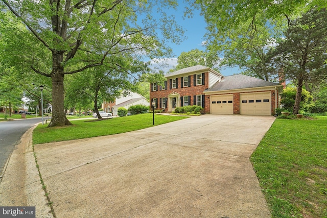 15320 Durant St, Silver Spring, MD 20905 - colonial-style house featuring a garage, driveway, brick siding, and a front lawn
