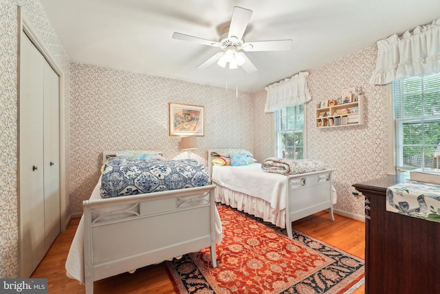 15320 Durant St, Silver Spring, MD 20905 - bedroom with wood finished floors, wallpapered walls, a closet, and a ceiling fan