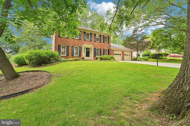 15320 Durant St, Silver Spring, MD 20905 - colonial house with brick siding, an attached garage, driveway, and a front yard