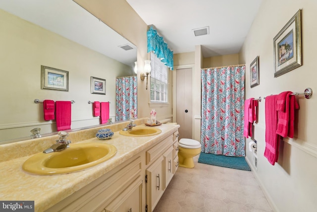 15320 Durant St, Silver Spring, MD 20905 - full bath with double vanity, toilet, curtained shower, and tile patterned floors