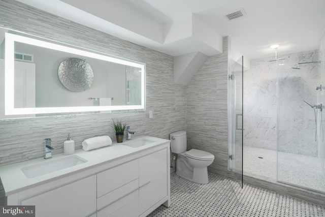 1212 E Susquehanna Ave Unit D, Philadelphia, PA 19125 - full bathroom featuring tile walls, a marble finish shower, toilet, double vanity, and tasteful backsplash