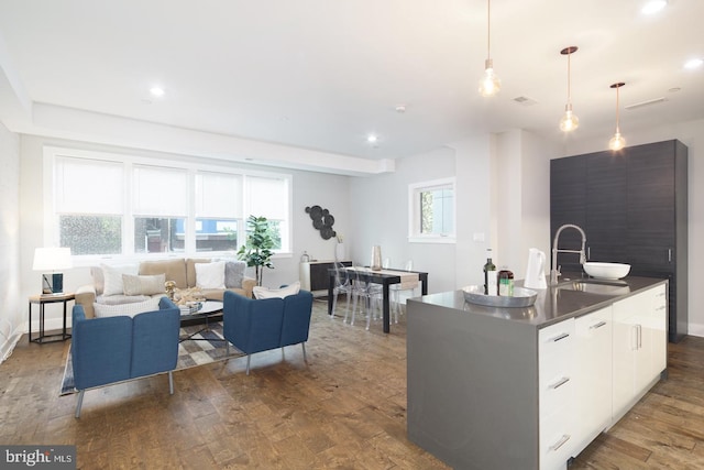1212 E Susquehanna Ave Unit D, Philadelphia, PA 19125 - kitchen featuring a sink, modern cabinets, wood finished floors, dark countertops, and pendant lighting