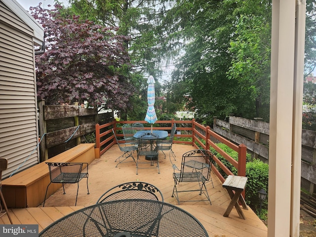 view of patio / terrace with outdoor dining area and a wooden deck