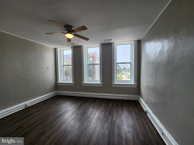1000 E Preston St, Baltimore, MD 21202 - empty room featuring dark wood-type flooring, baseboards, and a ceiling fan