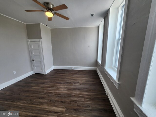 1000 E Preston St, Baltimore, MD 21202 - empty room featuring dark wood finished floors, ceiling fan, and baseboards