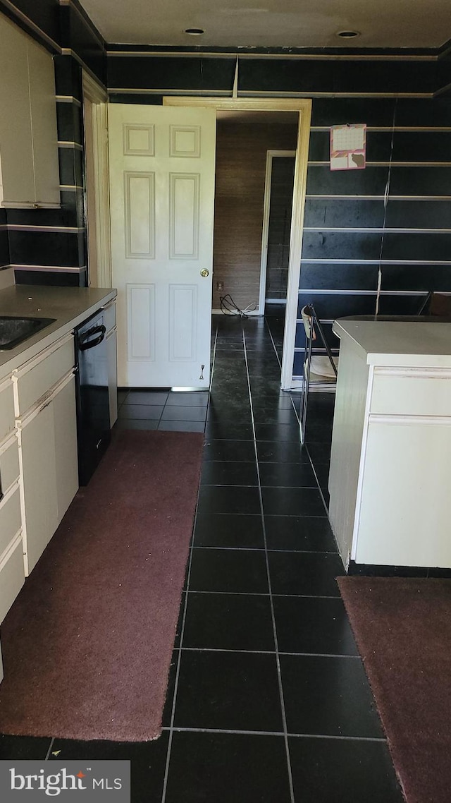kitchen featuring dishwasher, dark tile patterned floors, white cabinets, and open shelves