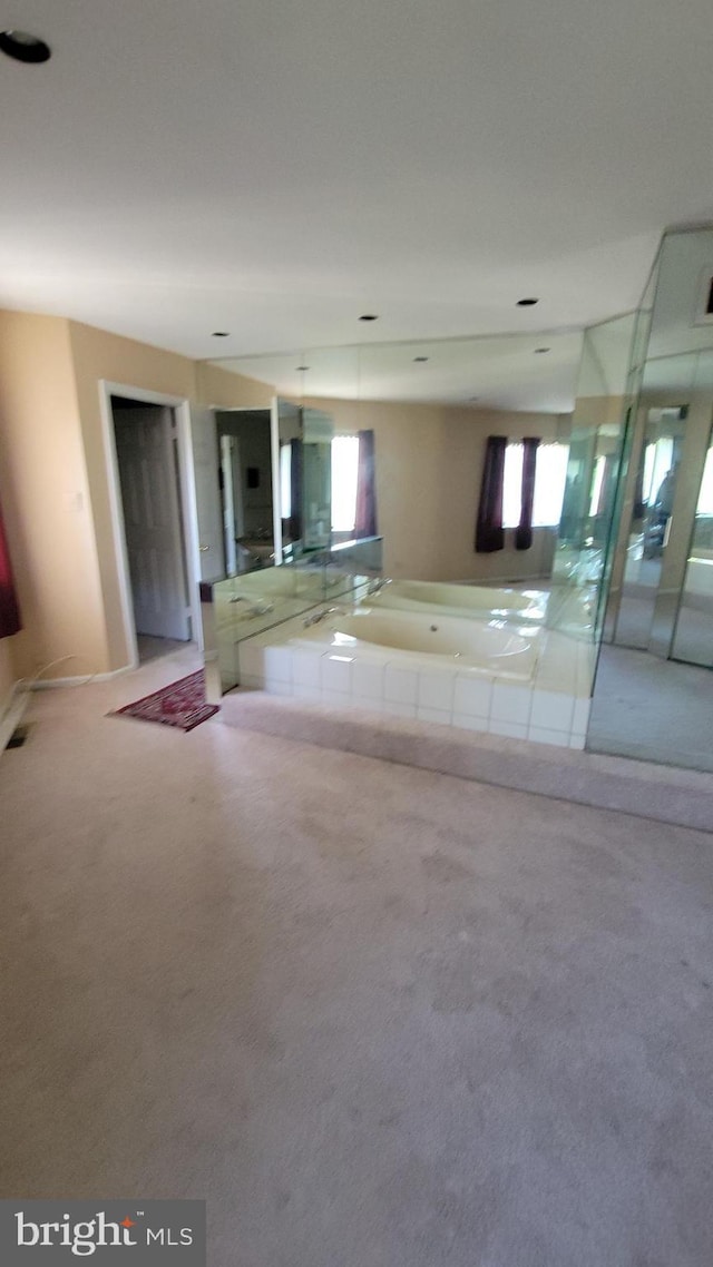 full bath featuring a shower with door, a bath, and carpet flooring