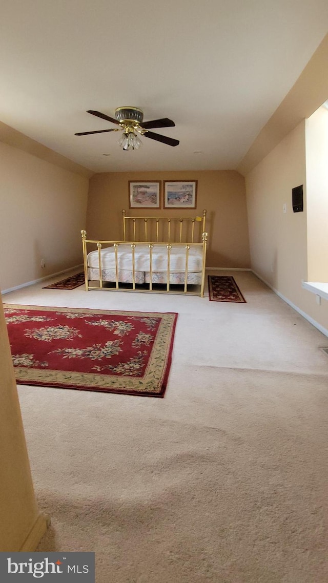 sitting room featuring carpet, ceiling fan, and baseboards