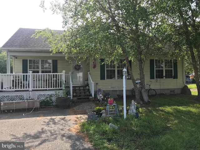 5294 Bucktown Rd, Cambridge, MD 21613 - view of front of home with covered porch, a shingled roof, and a front lawn