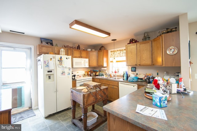 5294 Bucktown Rd, Cambridge, MD 21613 - kitchen featuring white appliances, hanging light fixtures, a sink, dark countertops, and brown cabinetry