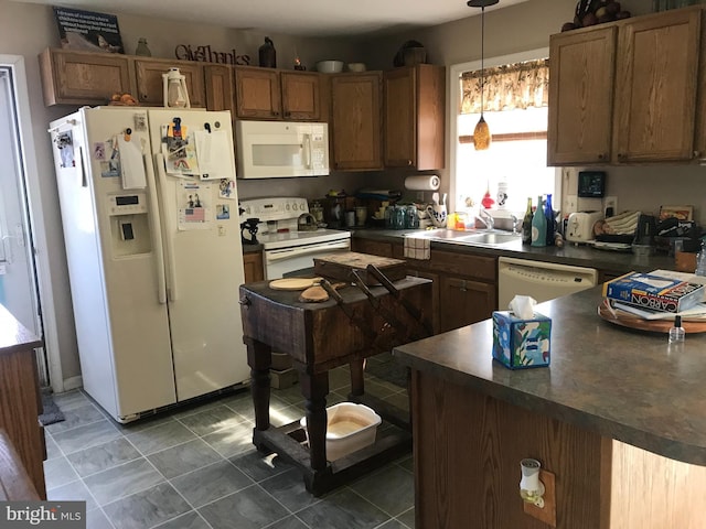 5294 Bucktown Rd, Cambridge, MD 21613 - kitchen featuring white appliances, a sink, dark countertops, decorative light fixtures, and brown cabinets