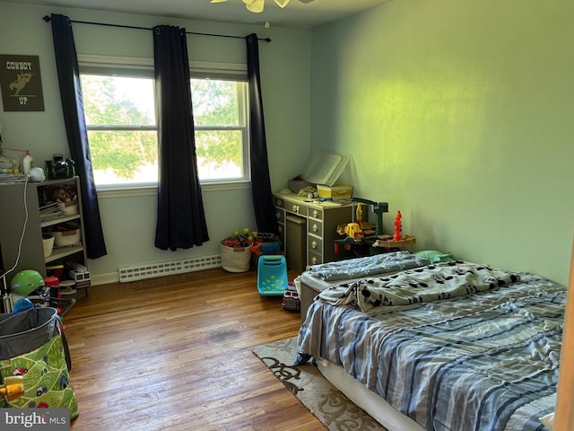 15510 Baden Naylor Rd, Brandywine, MD 20613 - bedroom with baseboard heating, wood finished floors, and baseboards