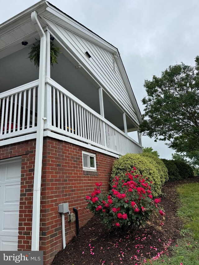 15510 Baden Naylor Rd, Brandywine, MD 20613 - view of home's exterior featuring a garage, brick siding, and a balcony