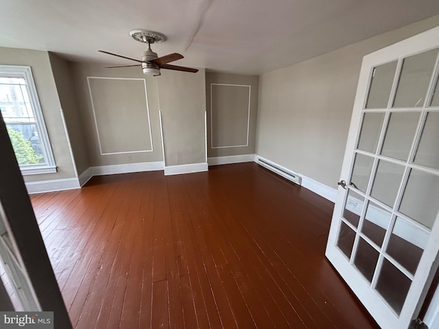 303 Main St, Ellendale, DE 19941 - unfurnished room with baseboard heating, baseboards, wood-type flooring, and ceiling fan