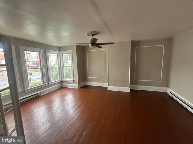 303 Main St, Ellendale, DE 19941 - spare room with baseboards, a baseboard radiator, dark wood-type flooring, and a ceiling fan