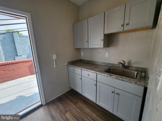 1000 E Preston St, Baltimore, MD 21202 - kitchen featuring a sink, dark wood-type flooring, and dark countertops