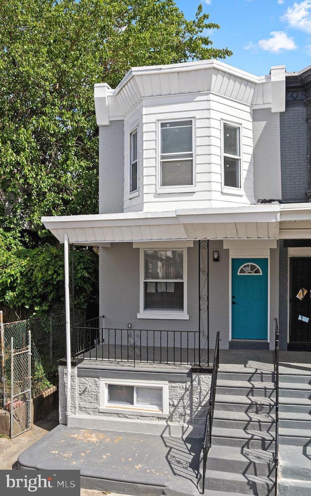 5514 Broomall St, Philadelphia, PA 19143 - view of front of property with covered porch, brick siding, and stairs
