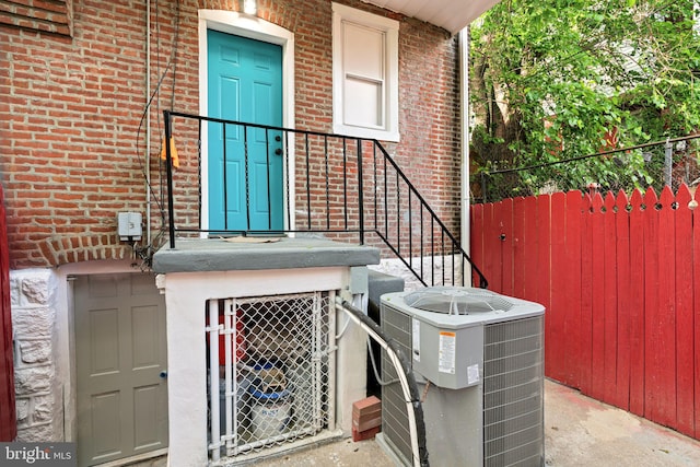 5514 Broomall St, Philadelphia, PA 19143 - doorway to property featuring cooling unit and brick siding