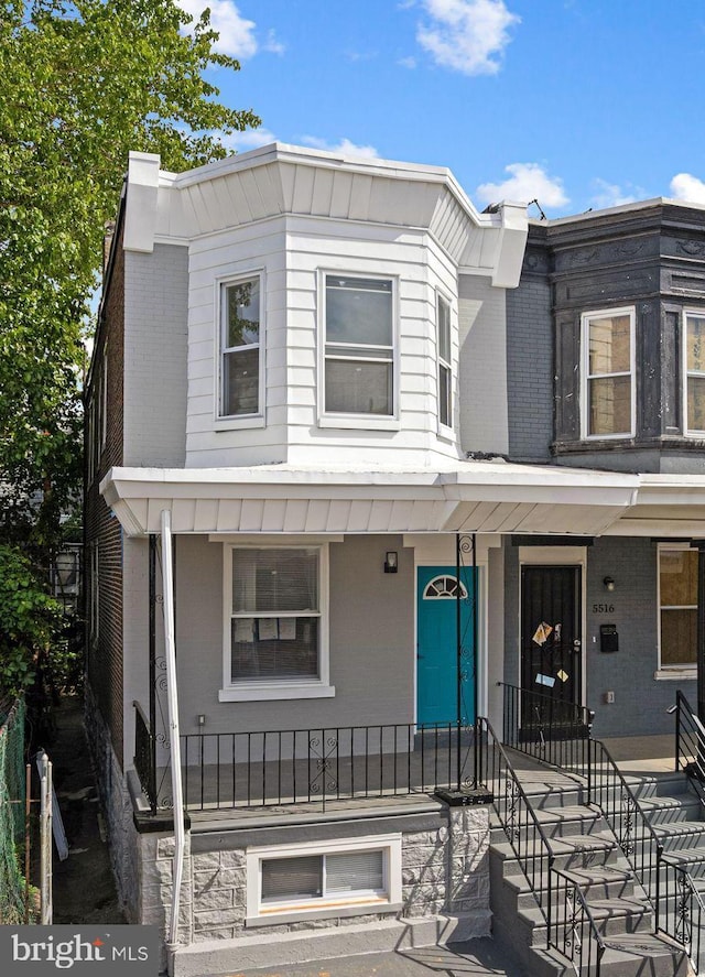 5514 Broomall St, Philadelphia, PA 19143 - view of front of property with brick siding and a porch