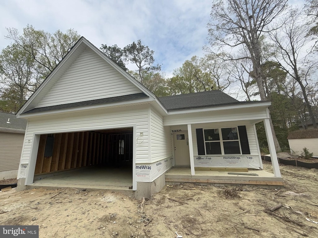 24 Admiral Ave, Ocean Pines, MD 21811 - view of front of property with covered porch, a garage, and roof with shingles