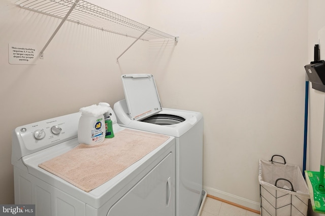 7305 Brookview Rd Unit 207, Elkridge, MD 21075 - laundry area with washing machine and dryer, baseboards, and light tile patterned floors