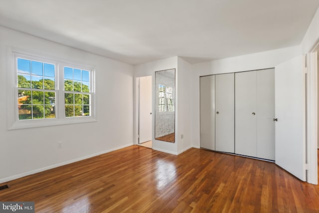 7602 Woodruff Ct, Laurel, MD 20707 - unfurnished bedroom featuring wood finished floors and baseboards