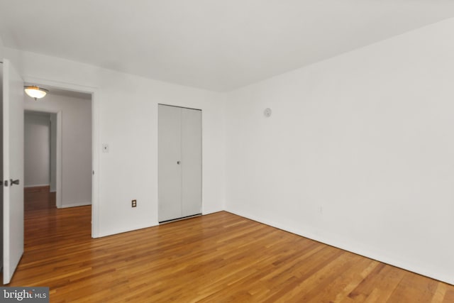 7602 Woodruff Ct, Laurel, MD 20707 - unfurnished bedroom with light wood-style flooring and a closet