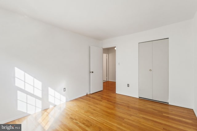 7602 Woodruff Ct, Laurel, MD 20707 - unfurnished bedroom with wood finished floors and a closet