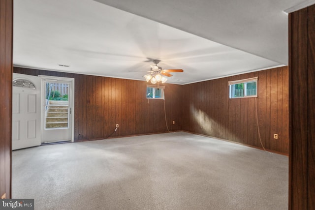 7602 Woodruff Ct, Laurel, MD 20707 - unfurnished room featuring wood walls, light colored carpet, and a ceiling fan