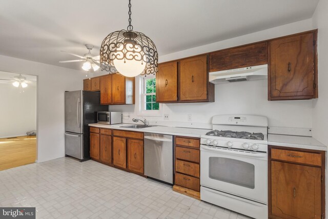 7602 Woodruff Ct, Laurel, MD 20707 - kitchen with stainless steel appliances, under cabinet range hood, light countertops, and a sink