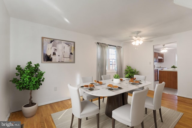7602 Woodruff Ct, Laurel, MD 20707 - dining area featuring light wood-style floors, a ceiling fan, and baseboards