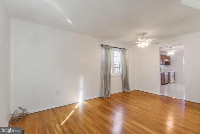 7602 Woodruff Ct, Laurel, MD 20707 - unfurnished living room with a ceiling fan, light wood-style floors, and baseboards